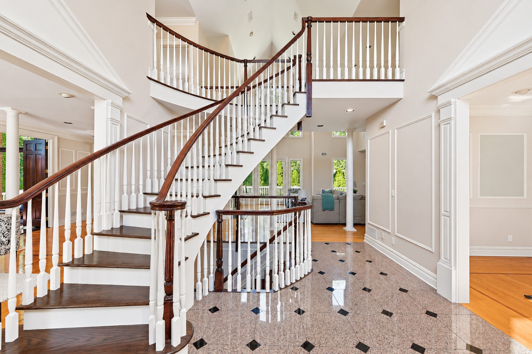 Two story foyer with sweeping staircase and checkerboard floor at 54 Burnet Hill Road, Livingston