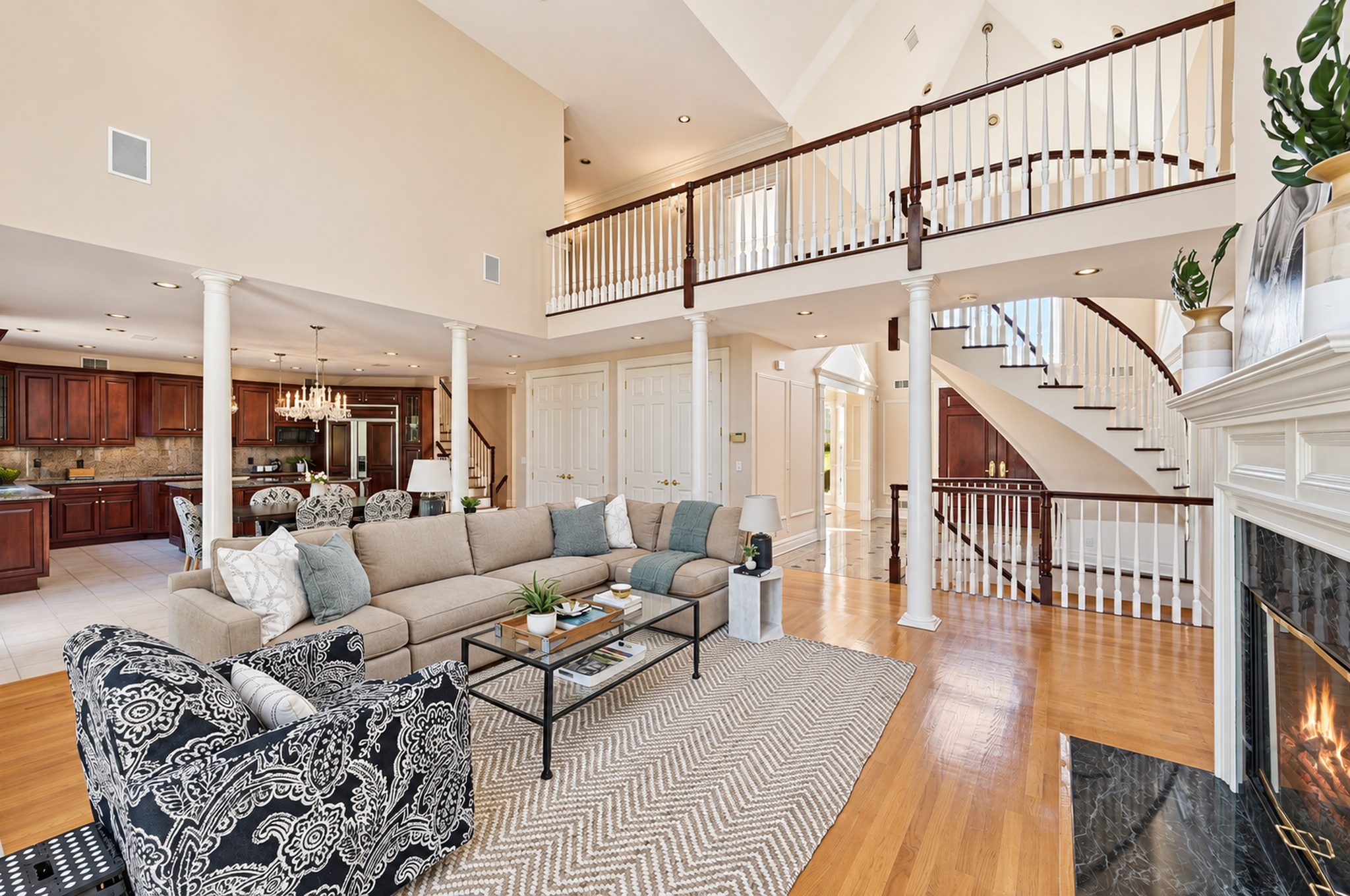 Two story family room with balcony overlook and fireplace at 54 Burnet Hill Road, Livingston