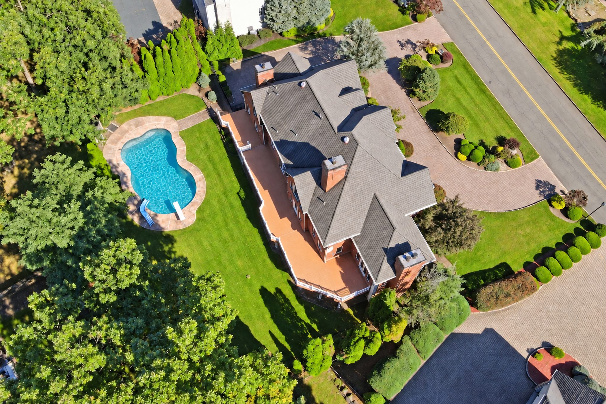 Aerial of the residence and rear yard with pool at 54 Burnet Hill Road, Livingston
